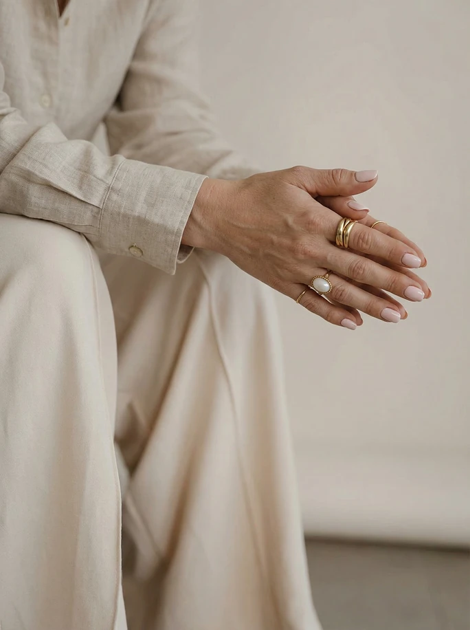 Monique sitting with her hands together